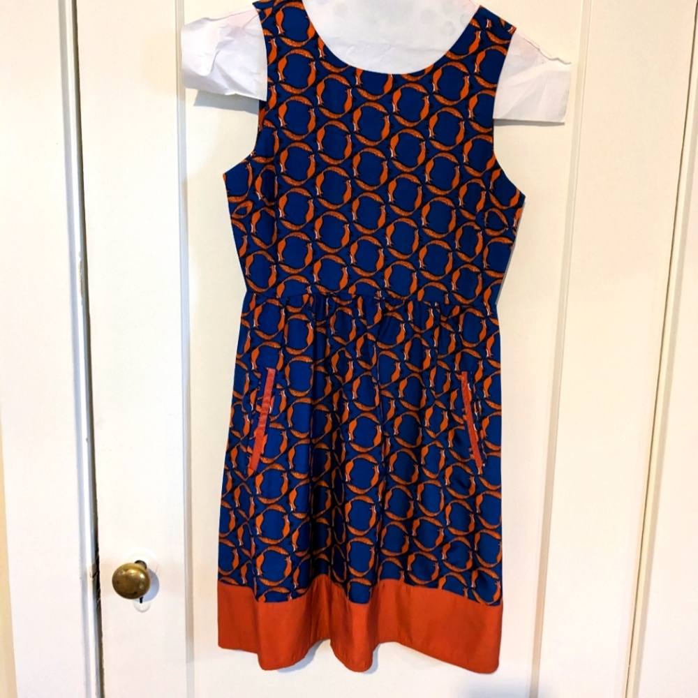 Sassy little sleeveless dress with pockets. Small, unique pattern of foxes.